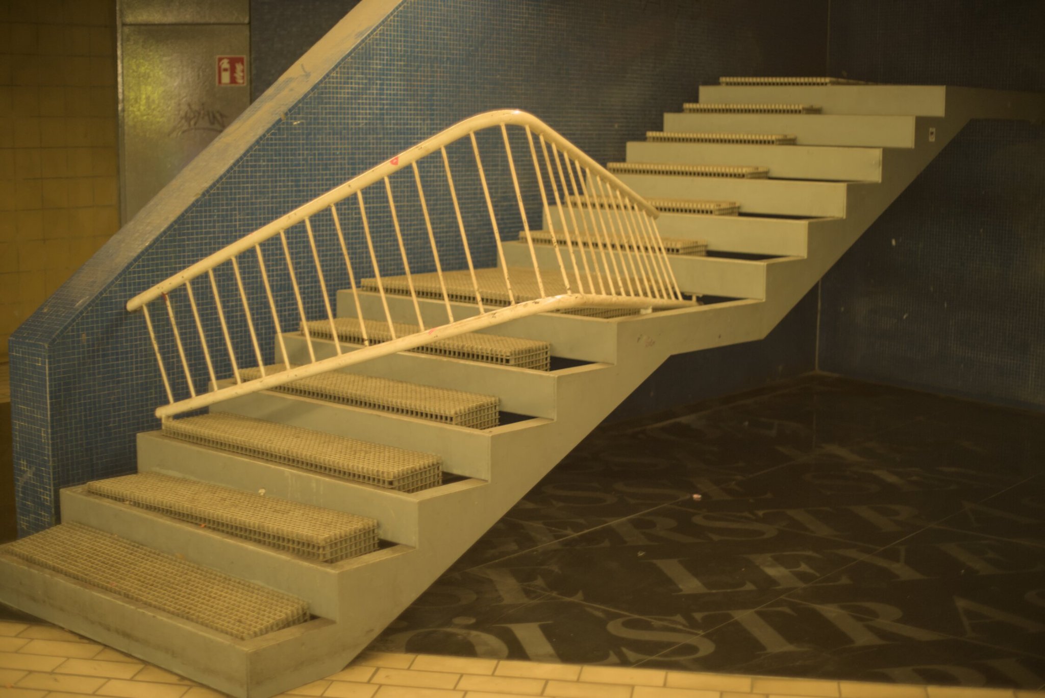 a stairway leading to nowhere, handrail broken off and bent to block entry upon it