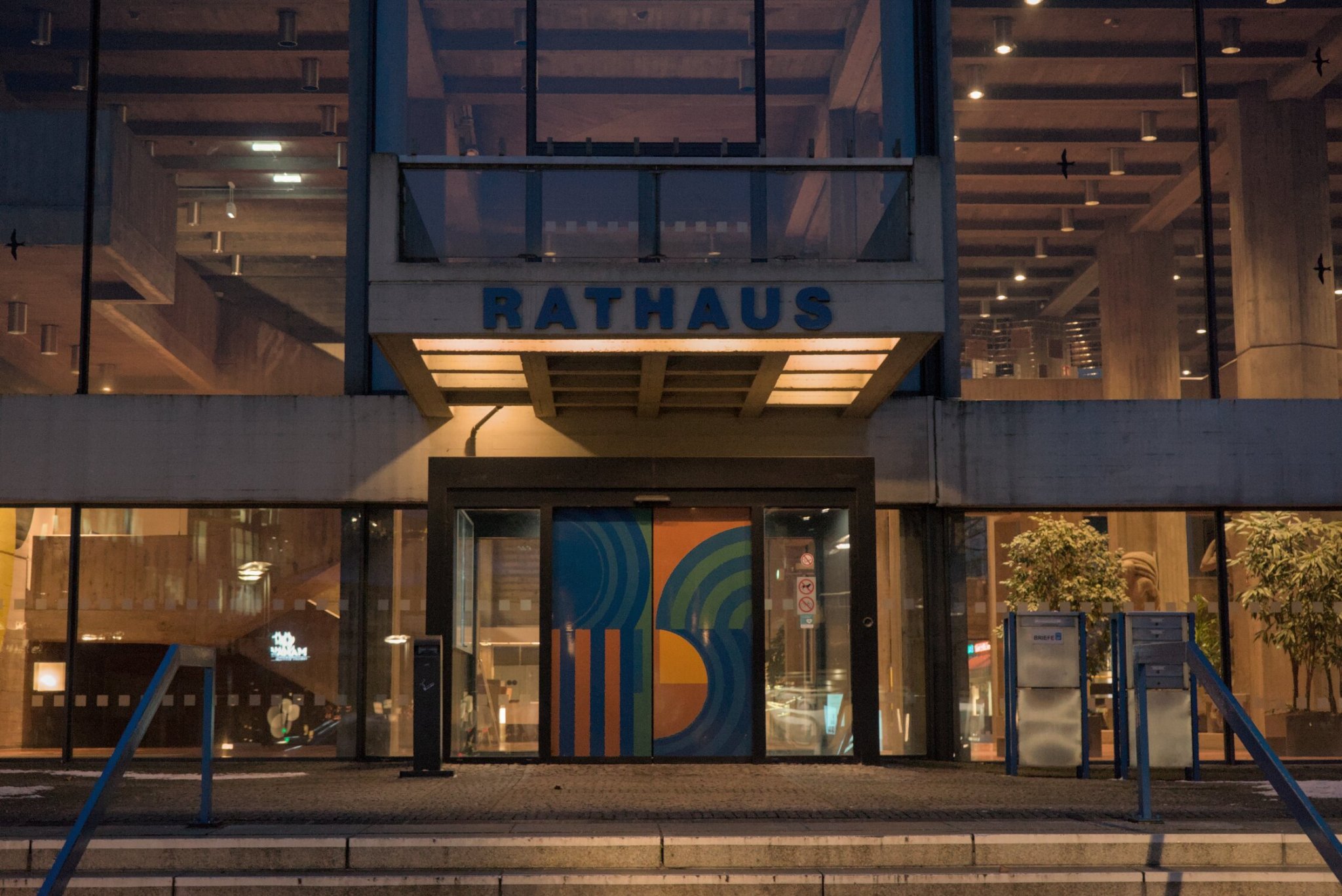 the front of a very official building labeled 'RATHAUS' (translates essentially to 'town hall') the interior looks quite warm and cozy on this cold winter's day