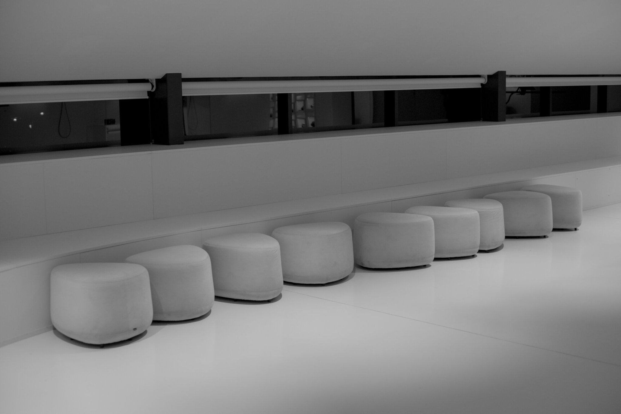 a monochrome set of seats, with a window behind