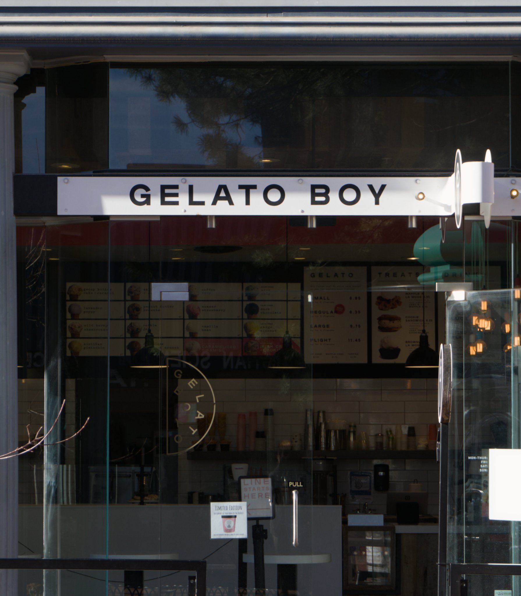 a gelato storefront, glass door open on this warm spring day, sign reading 'gelato boy'