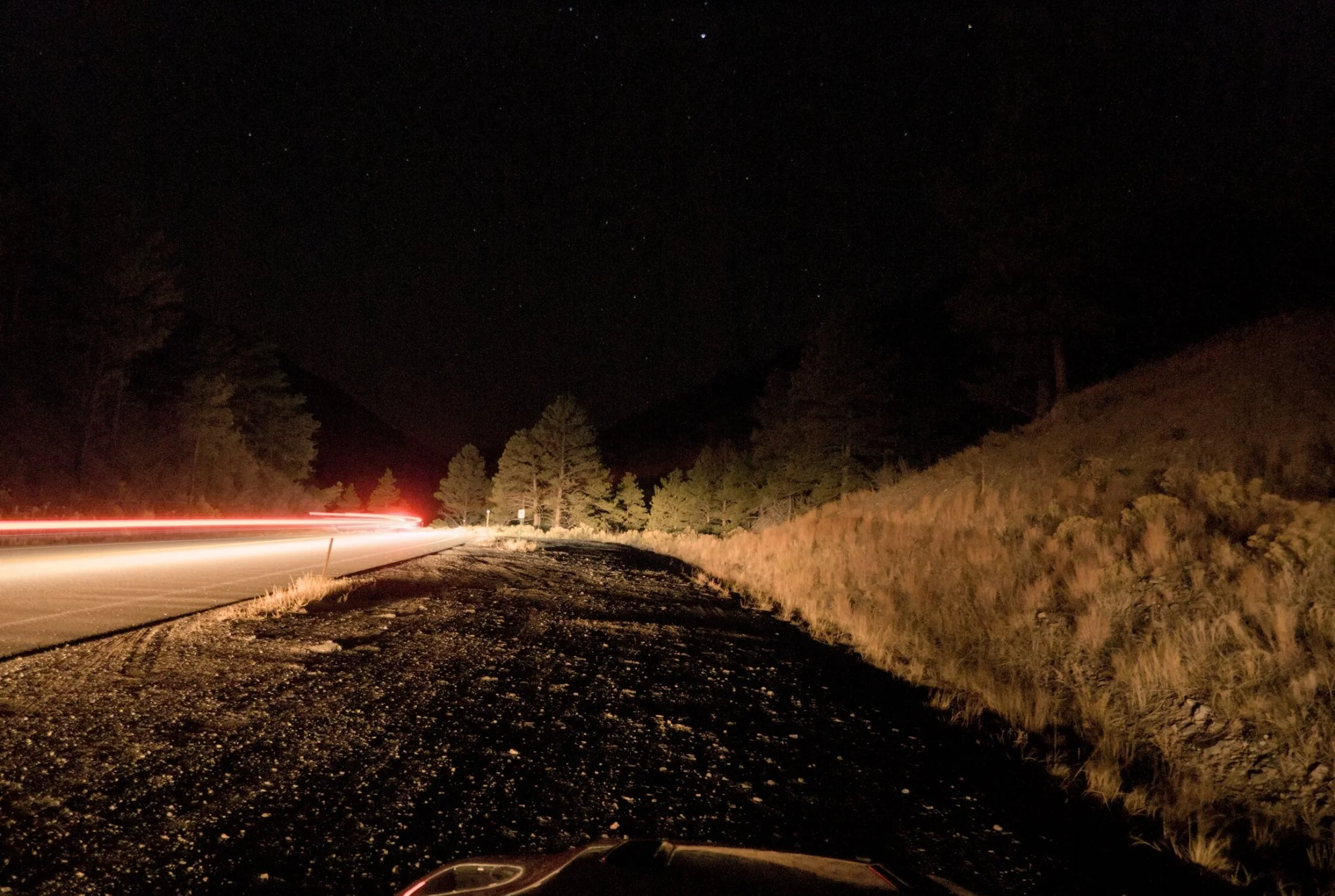 some light streaks passing by on the road adjacent