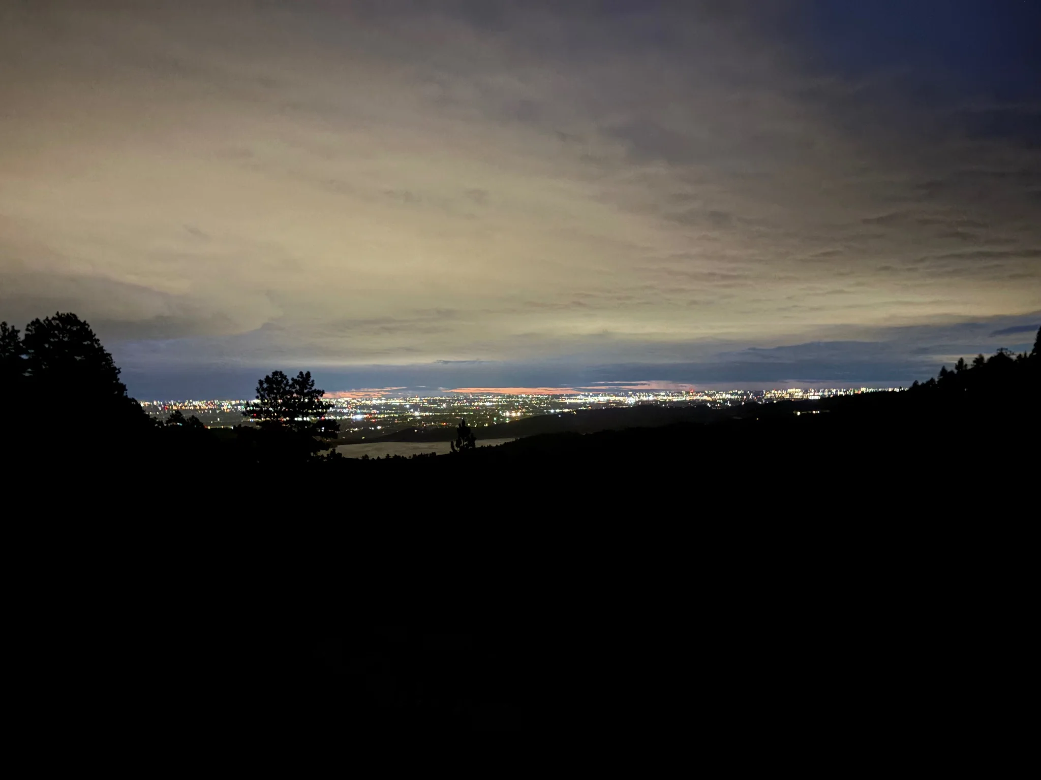 long exposure shot of city lights, midway up trail
the sky is fairly dark as is most of the scene, excluding the lights 