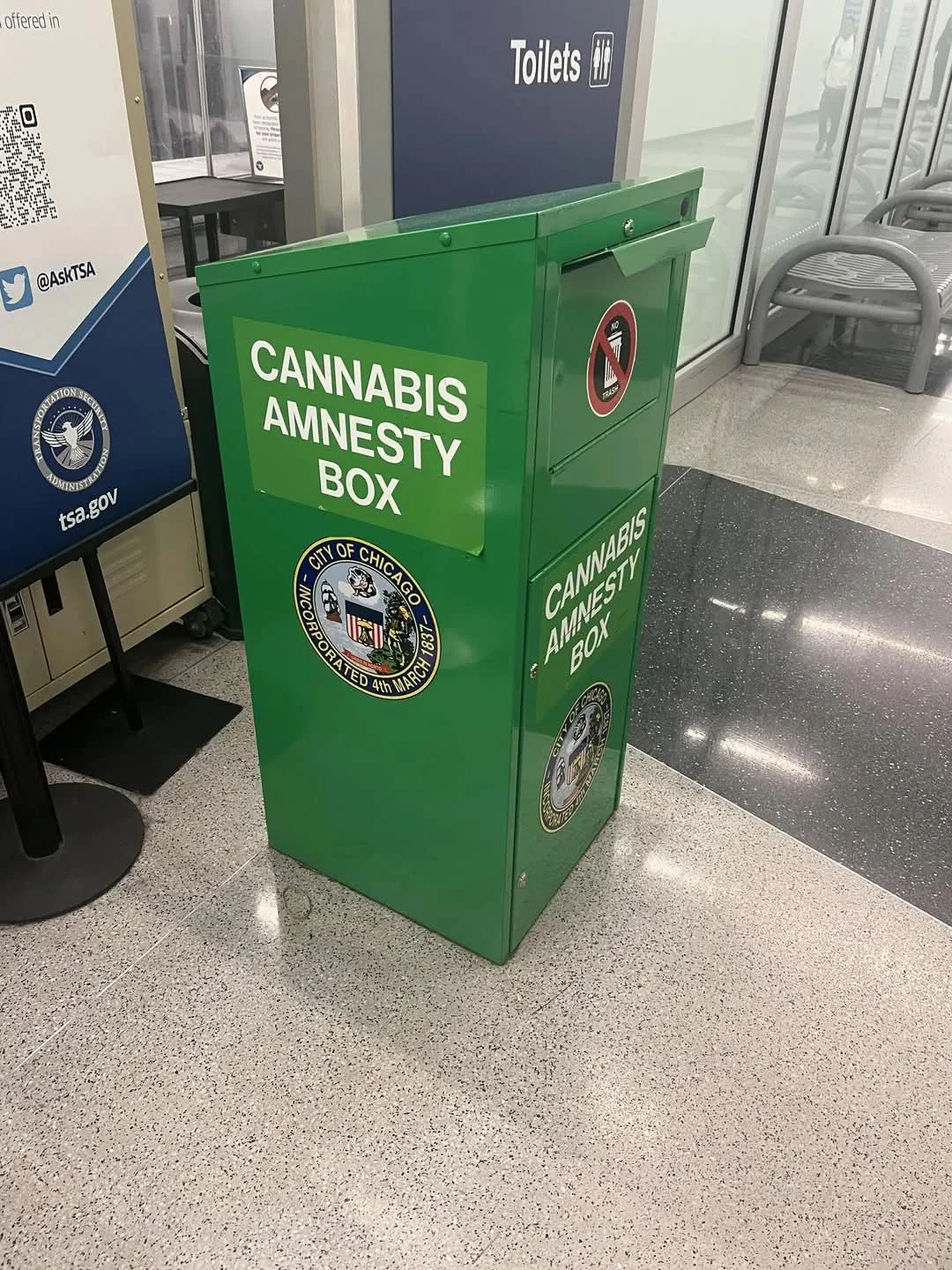 a green container that says "cannabis amnesty box" right next to tsa check