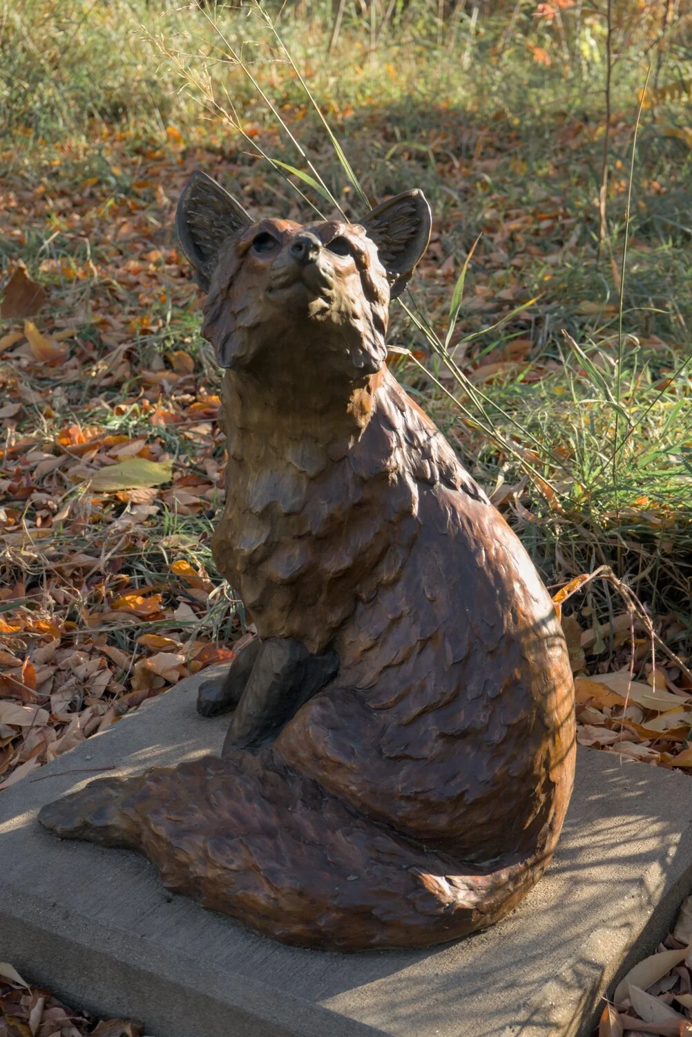 bronze fops statue, lookin real smug... autumn leaves are abound in the grass surrounding the statue