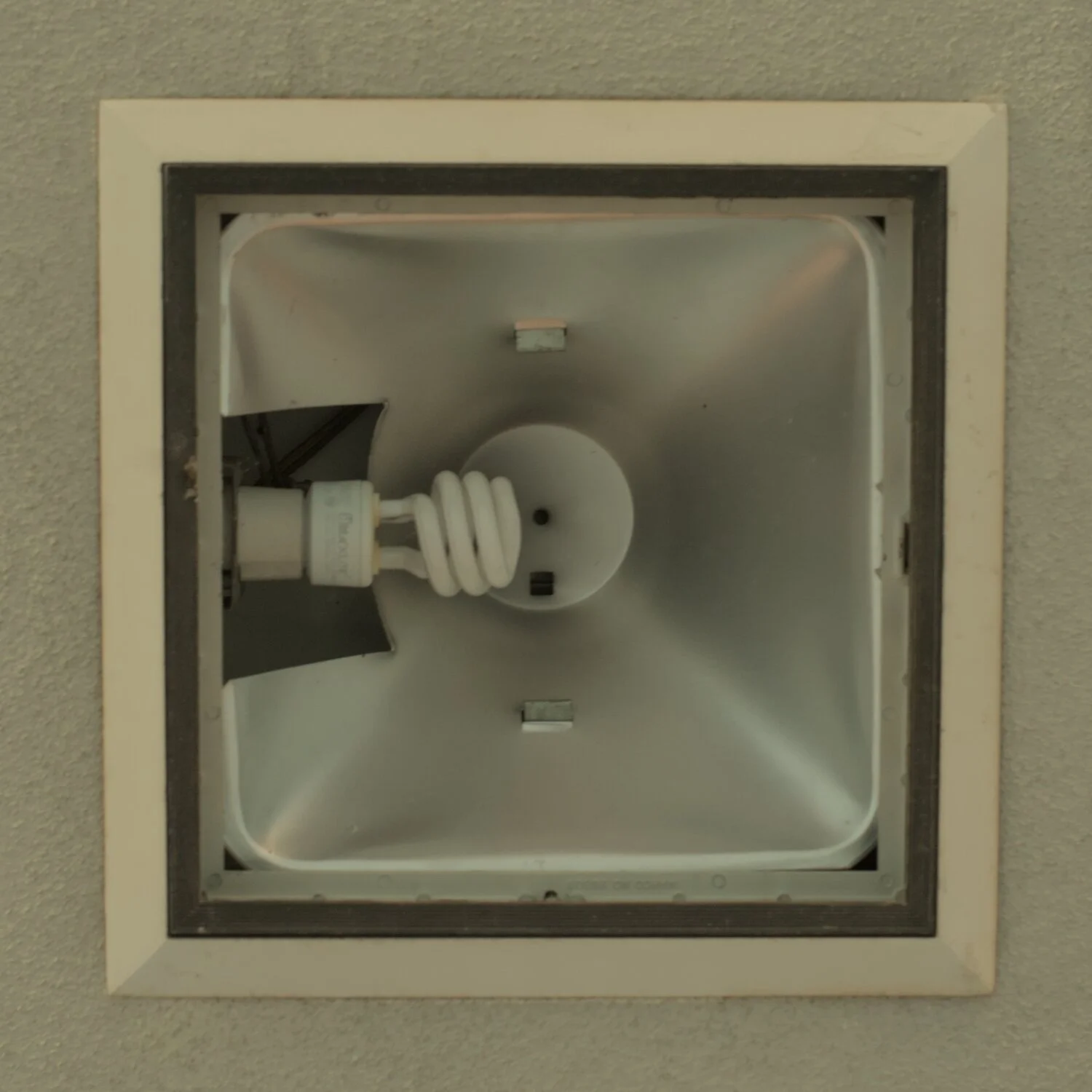a square light reflector, with a spiral cfl inside it